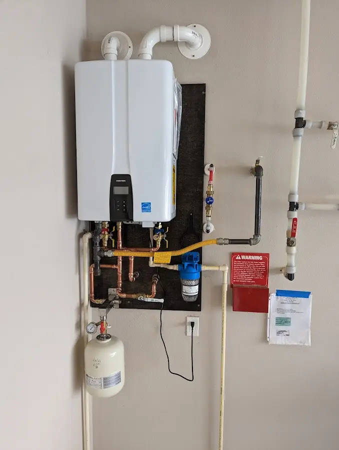 Professional plumber installing copper piping in a West Bridgewater home